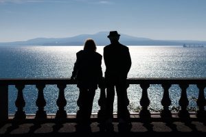 SIlhouette of couple at night looking out over water