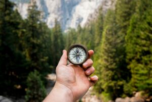 Hand holding a compass